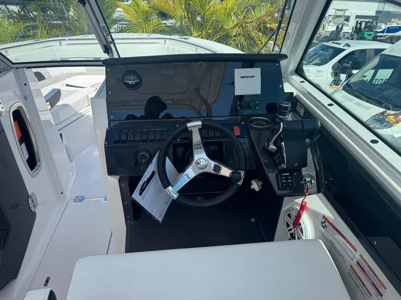 Slide: The Image of 2026 Blackfin 272 DC boat cockpit with steering wheel and control panel. - 25