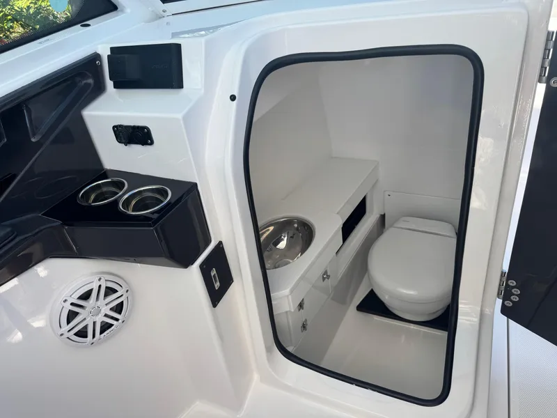 Slide: The Image of 2026 Blackfin 272 DC boat interior with compact bathroom and modern amenities. - 29