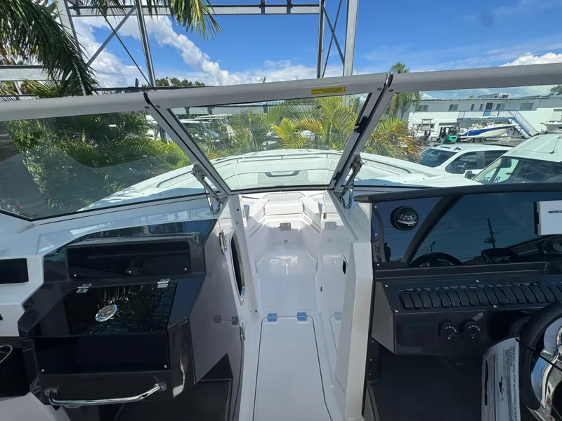 Slide: The Image of 2026 Blackfin 272 DC boat interior with open windshield, showcasing helm and dashboard controls. - 31