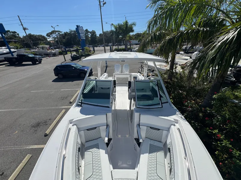 Slide: The Image of 2026 Blackfin 272 DC boat in a parking lot, surrounded by palm trees. - 37