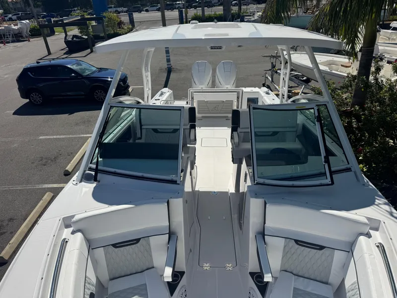 Slide: The Image of 2026 Blackfin 272 DC boat with open deck and seating, parked in a marina. - 38