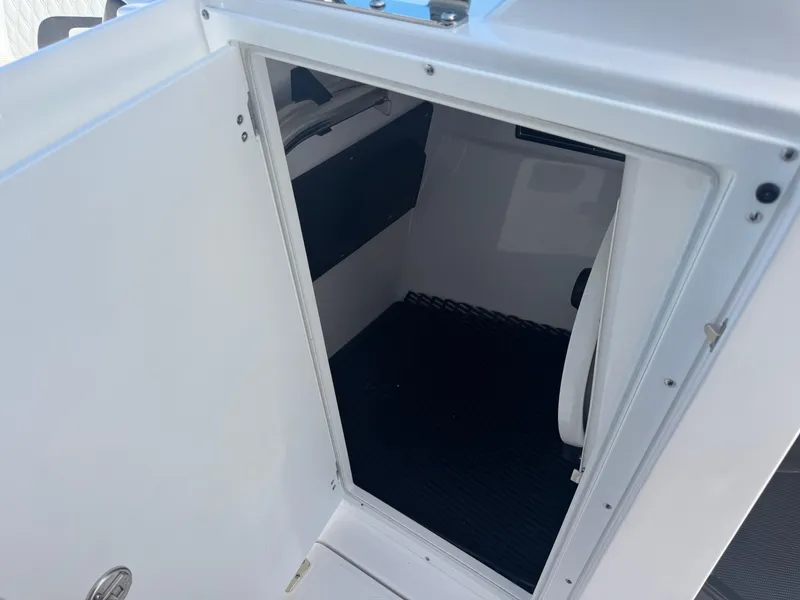 Slide: The Image of 2026 Blackfin 272 DC boat interior storage compartment with open door. - 39