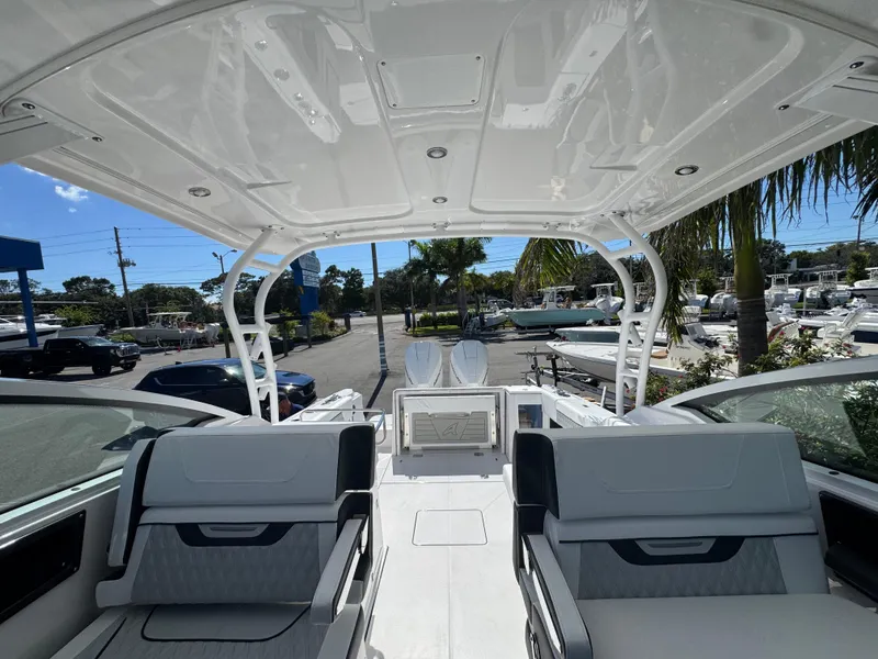 Slide: The Image of 2026 Blackfin 272 DC boat interior with seating, docked under clear sky. - 43