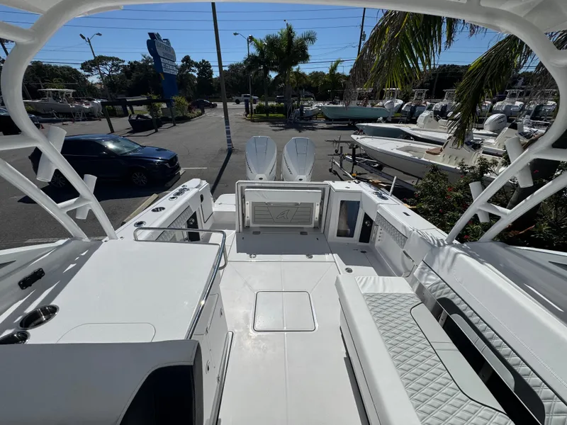 Slide: The Image of 2026 Blackfin 272 DC boat interior with seating and storage, parked at a marina. - 44