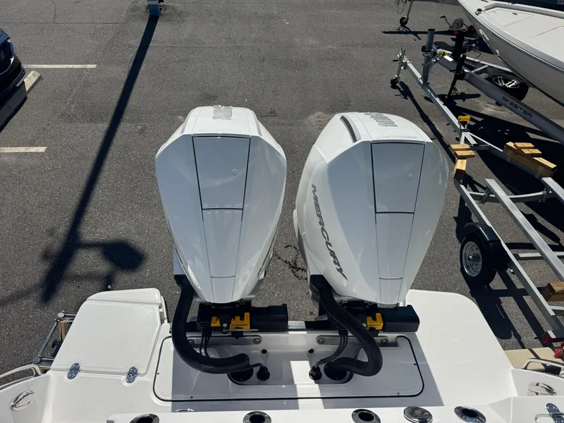 Slide: The Image of 2026 Blackfin 272 DC with dual Mercury outboard engines in a parking lot. - 47