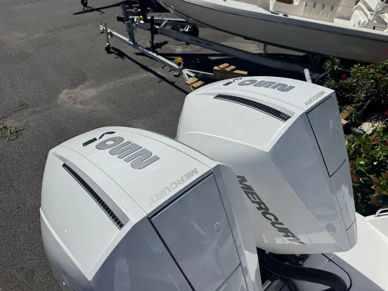 Slide: The Image of Twin Mercury outboard engines on a 2026 Blackfin 272 DC boat, parked on a trailer. - 48