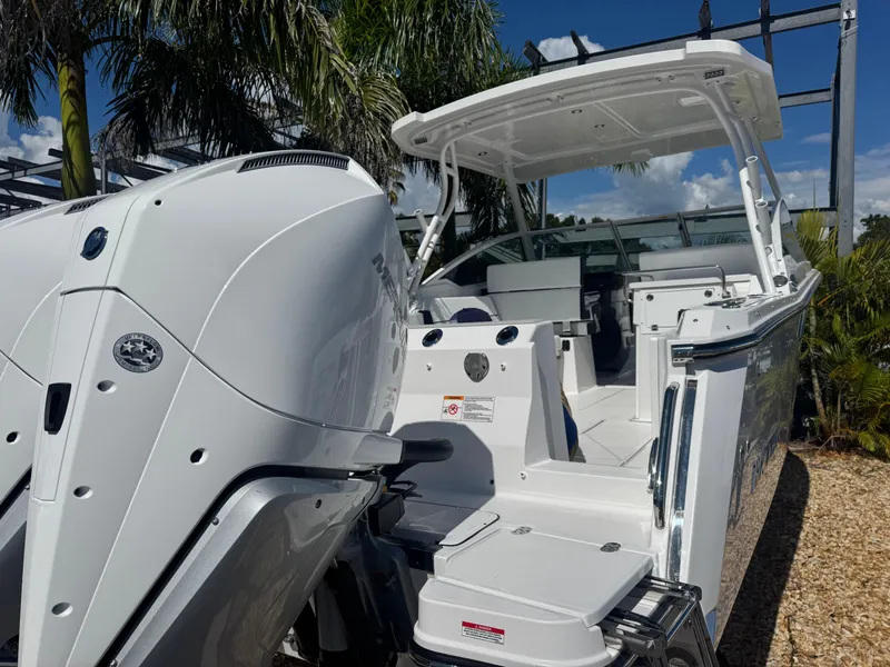 Slide: The Image of 2026 Blackfin 272 DC boat with dual engines, sleek design, and spacious deck under sunny skies. - 7