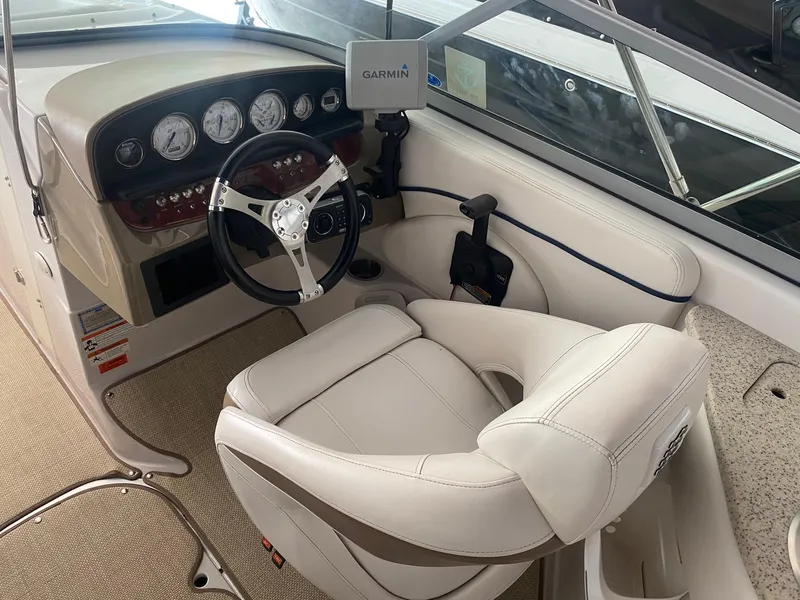 Slide: The Image of 2008 Four Winns H260 boat cockpit with steering wheel and Garmin navigation system. - 10