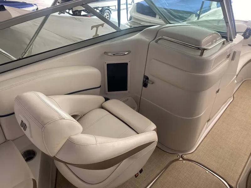 Slide: The Image of Interior of 2008 Four Winns H260 boat with white seating and dashboard. - 12