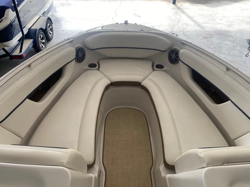 Slide: The Image of 2008 Four Winns H260 boat interior with beige seating and carpeted floor. - 13