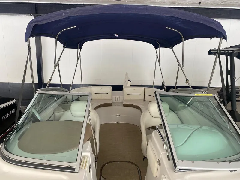 Slide: The Image of 2008 Four Winns H260 boat with blue canopy and spacious seating. - 14