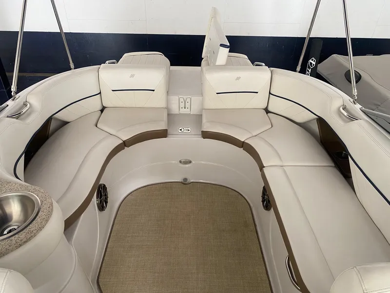 Slide: The Image of 2008 Four Winns H260 boat interior with beige seating and carpeted floor. - 15