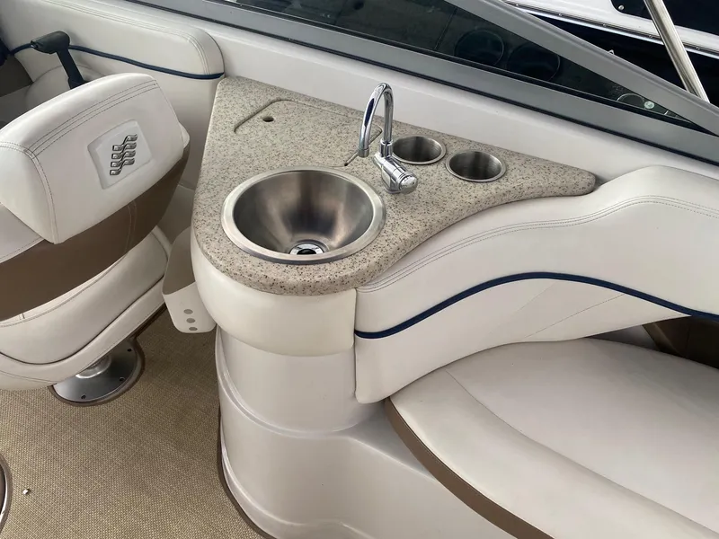 Slide: The Image of 2008 Four Winns H260 boat interior with sink and cup holders. - 16