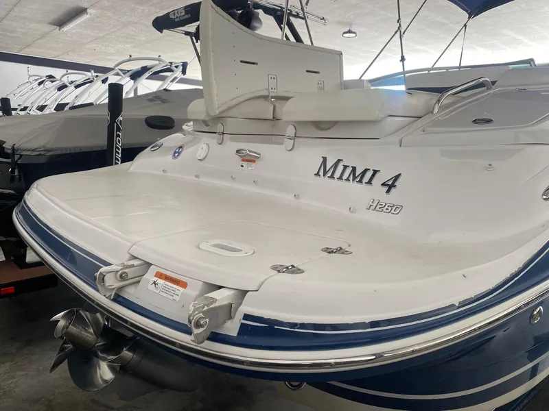 Slide: The Image of 2008 Four Winns H260 boat named "Mimi 4" in storage, rear view. - 4