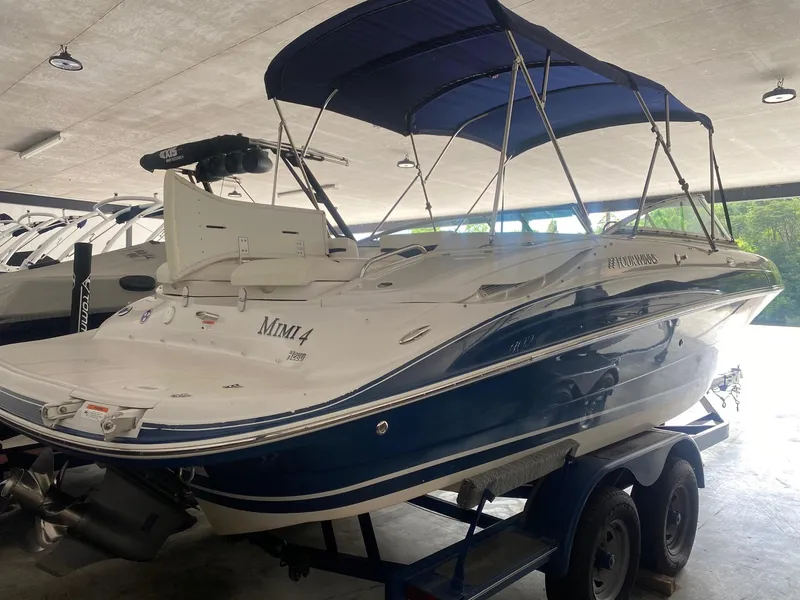 Slide: The Image of 2008 Four Winns H260 boat with blue canopy on trailer in storage facility. - 5