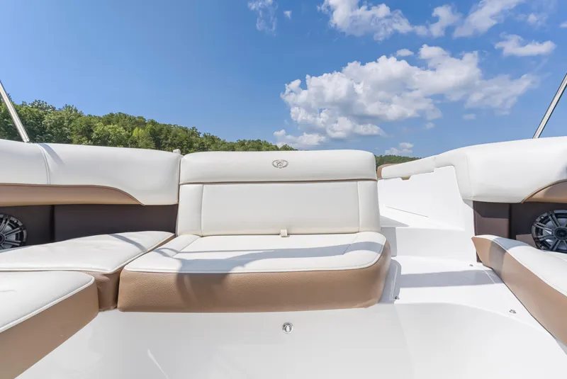 Slide: The Image of 2016 Cobalt 200 boat interior with white and tan seating under a blue sky. - 11