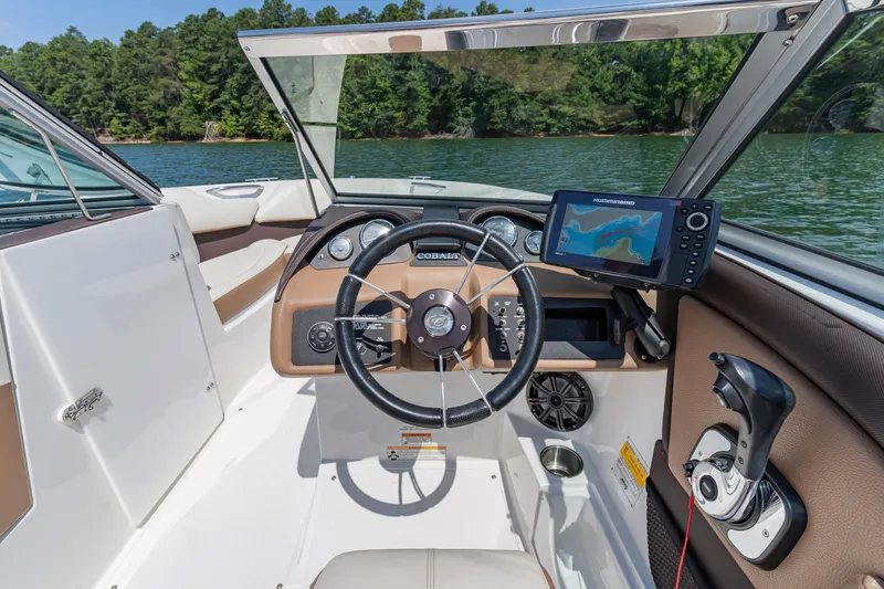 Slide: The Image of Interior of a 2016 Cobalt 200 boat with steering wheel and navigation system. - 17