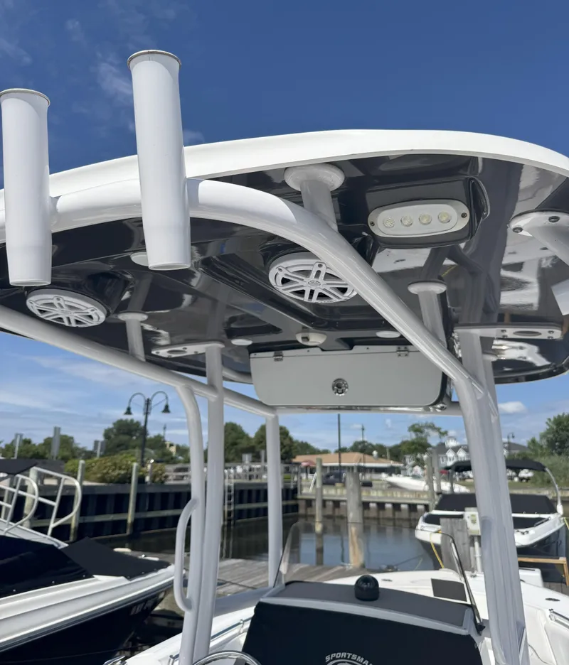 Slide: The Image of 2022 Sportsman Open 232 Center Console boat with T-top and rod holders. - 4