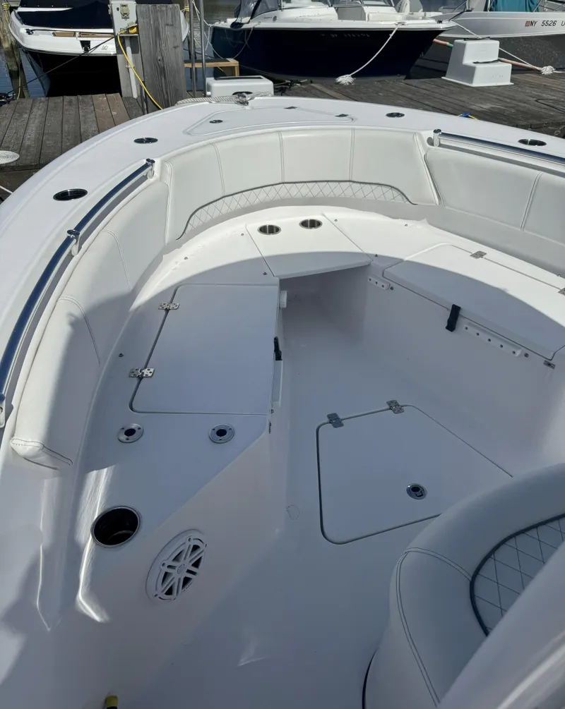 Slide: The Image of 2022 Sportsman Open 232 Center Console boat interior with seating and storage compartments. - 5
