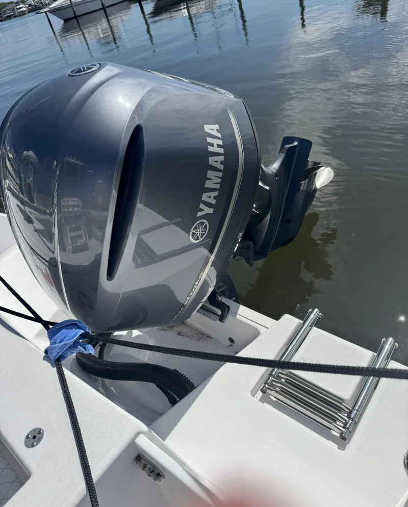 Slide: The Image of Yamaha outboard motor on 2022 Sportsman Open 232 Center Console boat, docked by water. - 8
