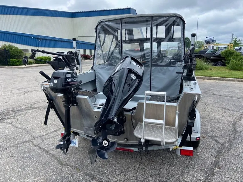 Slide: The Image of 2018 Hewescraft 160 Sportsman boat with dual outboard motors and protective canopy. - 3