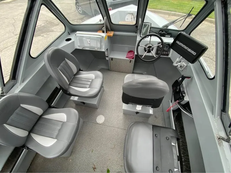 Slide: The Image of 2018 Hewescraft 160 Sportsman boat interior with gray seating and steering console. - 4