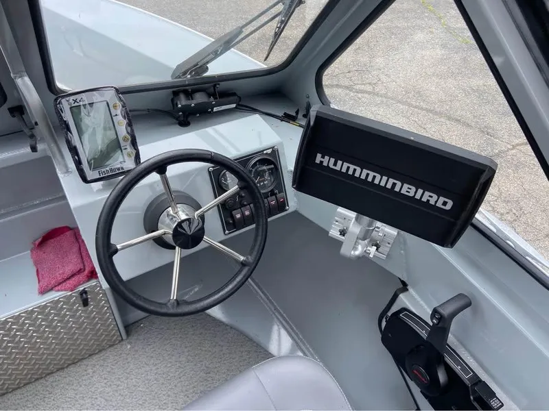Slide: The Image of 2018 Hewescraft 160 Sportsman boat dashboard with steering wheel and Humminbird fish finder. - 6