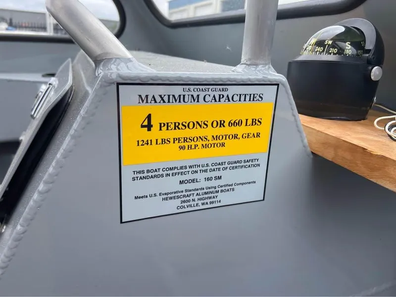 Slide: The Image of 2018 Hewescraft 160 Sportsman capacity label, showing limits for persons and weight. - 9