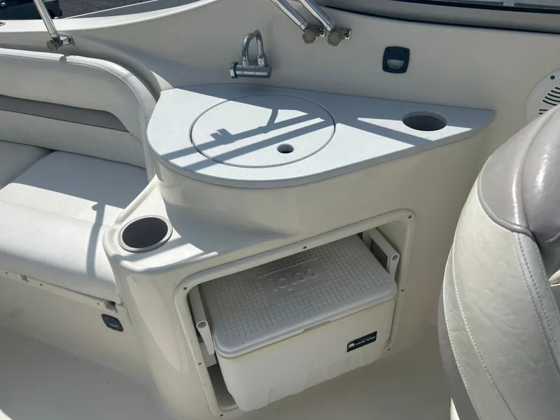 Slide: The Image of 2005 Stingray 250 LR boat interior with sink, seating, and built-in cooler storage. - 11