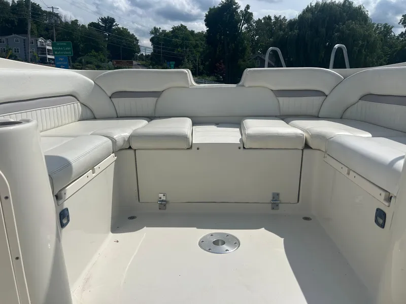 Slide: The Image of 2005 Stingray 250 LR boat interior with white cushioned seating and open deck space. - 12