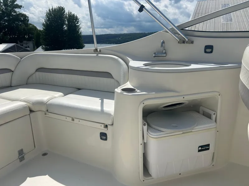 Slide: The Image of 2005 Stingray 250 LR boat interior with seating, sink, and storage compartment. - 13