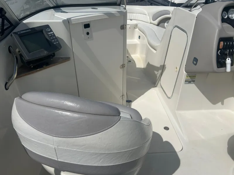 Slide: The Image of 2005 Stingray 250 LR boat interior with seating and navigation equipment. - 14