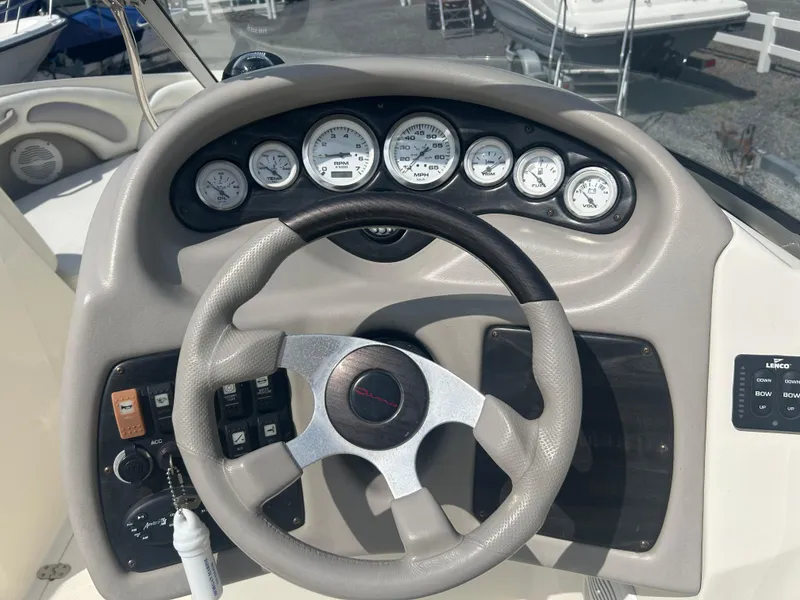 Slide: The Image of Dashboard of a 2005 Stingray 250 LR boat with steering wheel and gauges. - 15