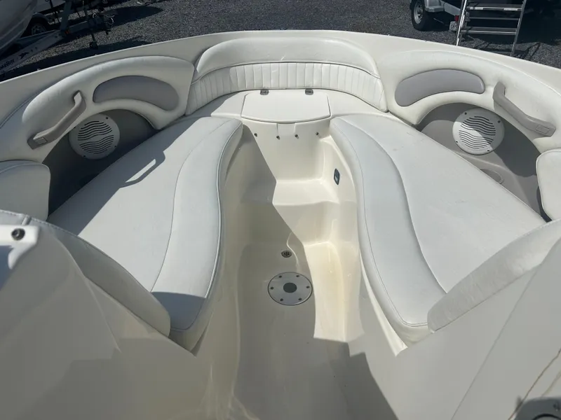 Slide: The Image of 2005 Stingray 250 LR boat interior with white cushioned seating and speakers. - 16