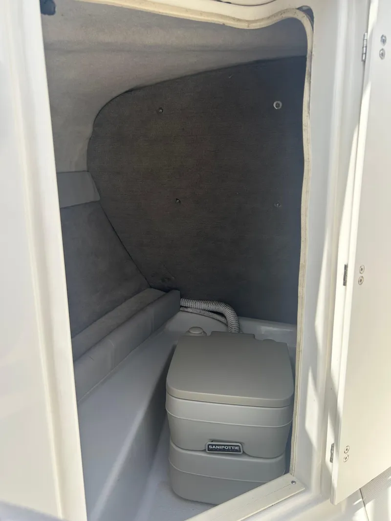 Slide: The Image of Interior of a 2005 Stingray 250 LR boat with a portable toilet. - 19