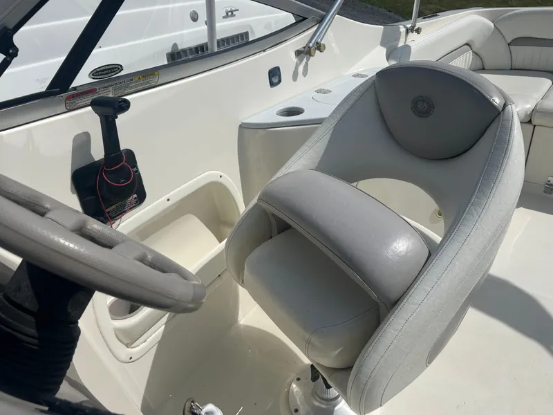 Slide: The Image of 2005 Stingray 250 LR boat interior with steering wheel and cushioned seat. - 20