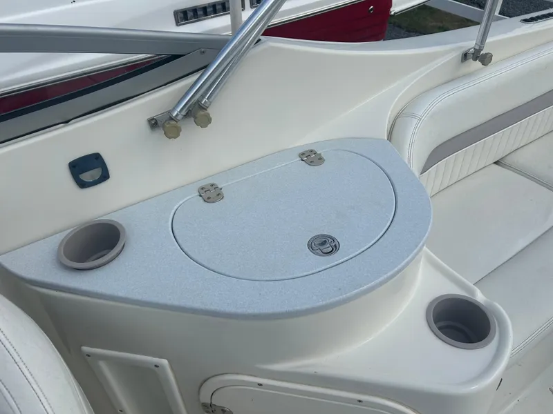 Slide: The Image of 2005 Stingray 250 LR boat interior with seating and storage compartment. - 22