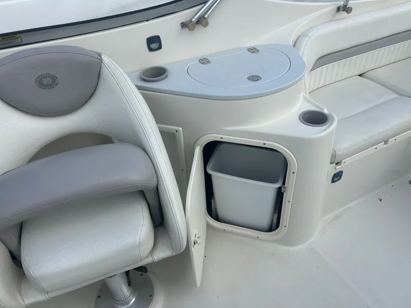 Slide: The Image of 2005 Stingray 250 LR boat interior with seating and storage compartment. - 23