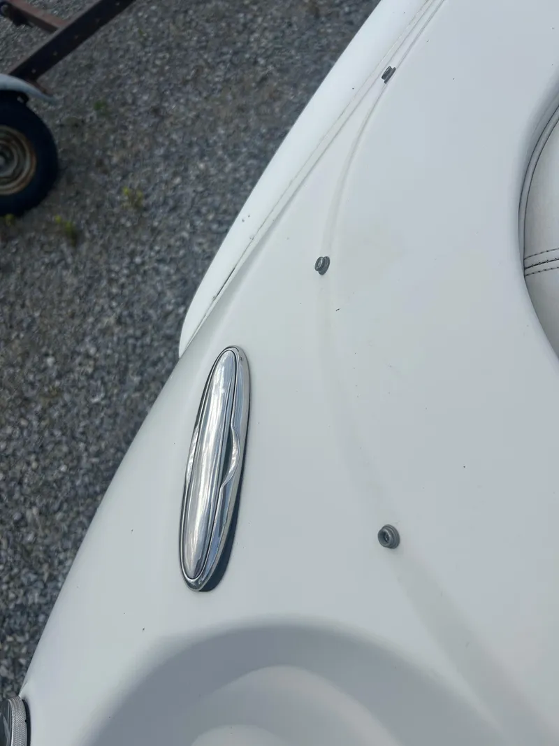 Slide: The Image of Close-up of a 2005 Stingray 250 LR boat detail on gravel surface. - 27