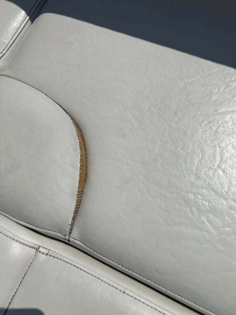 Slide: The Image of Torn white upholstery on 2005 Stingray 250 LR boat seat. - 29