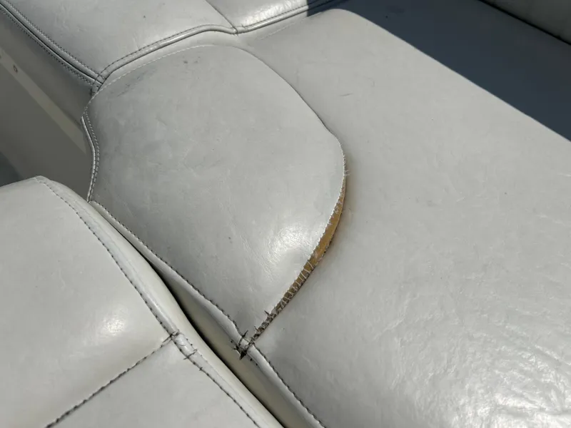 Slide: The Image of Torn upholstery on a 2005 Stingray 250 LR boat seat, showing wear and damage. - 30