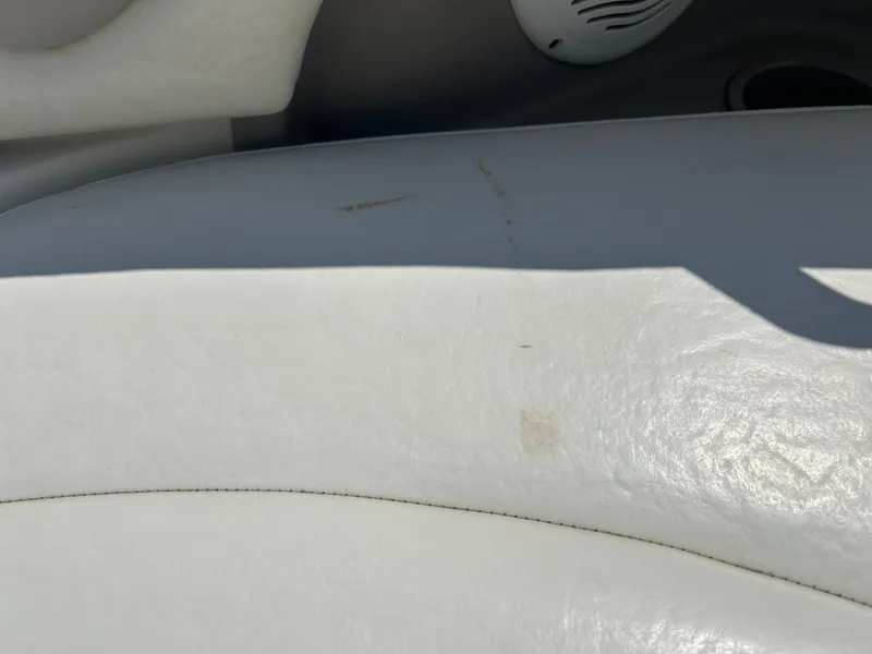 Slide: The Image of White leather seat with minor stains on a 2005 Stingray 250 LR boat. - 34