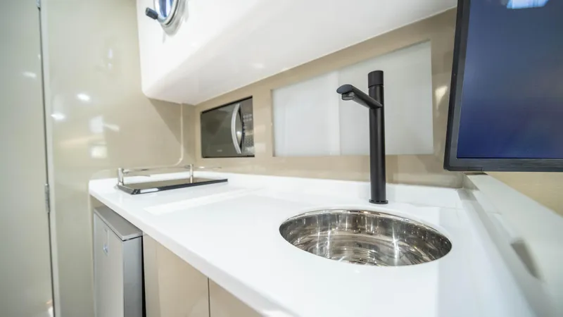 Slide: The Image of Modern kitchen area in 2025 Hanover 387 Outboard boat with sleek sink and appliances. - 34