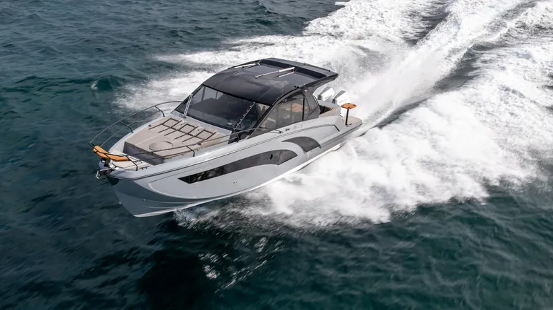 Slide: The Image of 2025 Hanover 387 Outboard cruising on open water, showcasing sleek design and powerful performance. - 6
