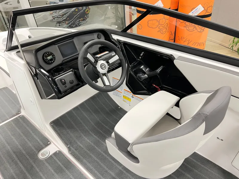 Slide: The Image of 2025 Yamaha Boats AR190 interior with white seating and storage compartment. - 8