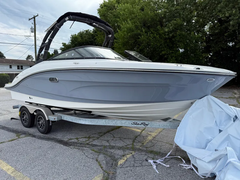 Slide: The Image of 2025 Sea Ray SPX 210 boat on trailer, parked outdoors. - 1