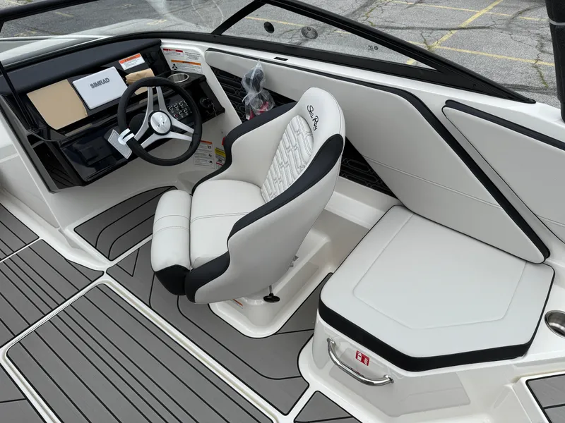 Slide: The Image of 2025 Sea Ray SPX 210 boat interior with sleek steering and comfortable seating. - 11