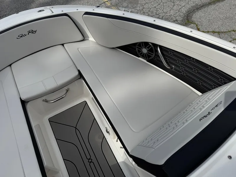 Slide: The Image of 2025 Sea Ray SPX 210 boat interior with white seating and sleek design. - 17