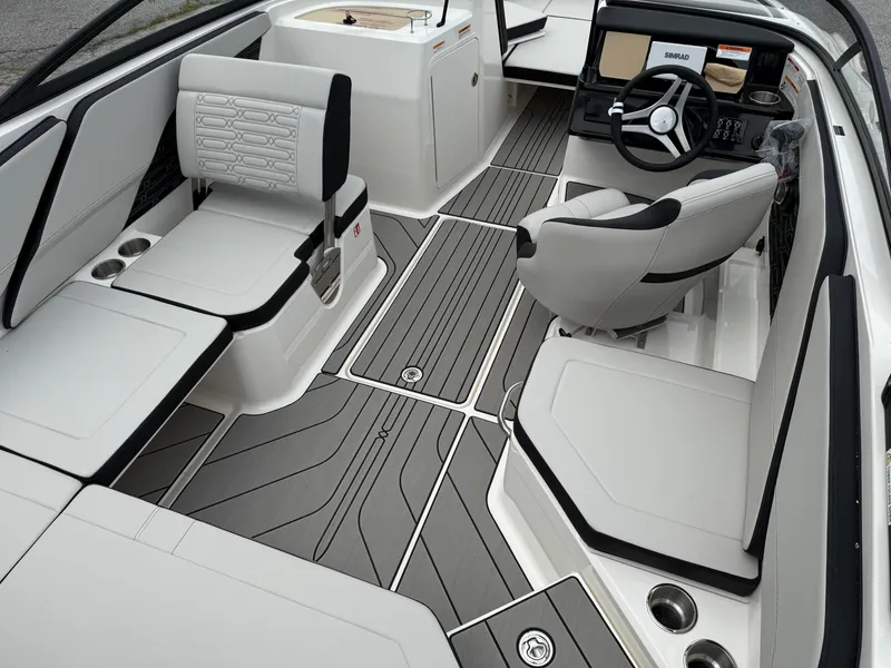 Slide: The Image of Interior of 2025 Sea Ray SPX 210 boat with modern seating and steering wheel. - 7