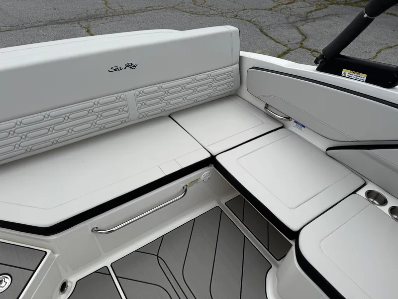 Slide: The Image of Interior seating of 2025 Sea Ray SPX 210 boat, featuring sleek white upholstery. - 8